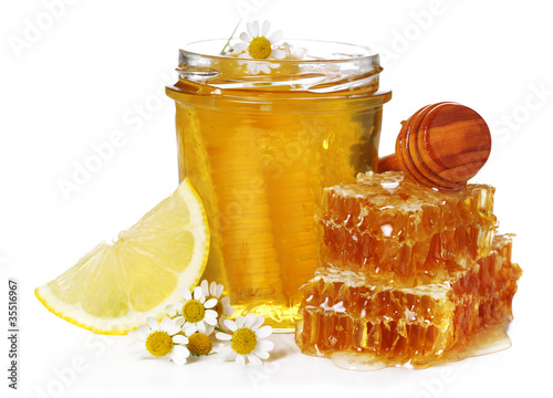 Photo: Fresh honey, chamomile and lemon on white isolated background Fresh honey, chamomile and lemon on white isolated background