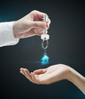 Man is handing a house key to a woman