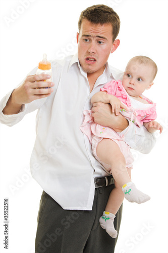 Photo: A young father with a baby on a white background. A young father with a baby on a white background.