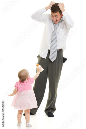 Photo: A young father with a baby on a white background. A young father with a baby on a white background.