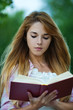 young woman reading red book