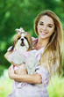 young woman holds dog her arms