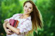 young woman holds lot books