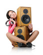 Young girl with headphones and two speakers on white Young girl with headphones and two speakers on white