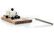blue cheese on cheeseboard decorated with black olives