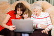 Family on a sofa with computer