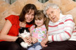Family on sofa with a cat