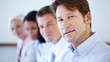 Closeup of business man smiling with team
