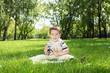 Portrait of a boy with a book in the park