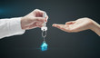 Man is handing a house key to a woman