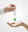 Man is handing a house key to a woman