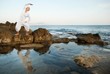 Young woman doing yoga exercise outdoors