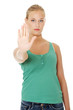 Young woman making stop gesture.