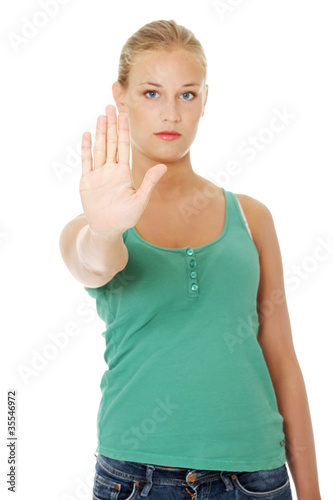 Photo: Young woman making stop gesture. Young woman making stop gesture.