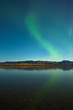 Northern lights and fall colors at calm lake