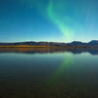 Northern lights and fall colors at calm lake