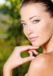 Woman stroking her fresh clean skin of face