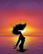 Silhouette of a woman in the sea at sunset.