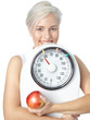 Girl with apple and scales is happy about ideal body weight