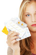 Foto: Young beautiful woman with pills. Young beautiful woman with pills.