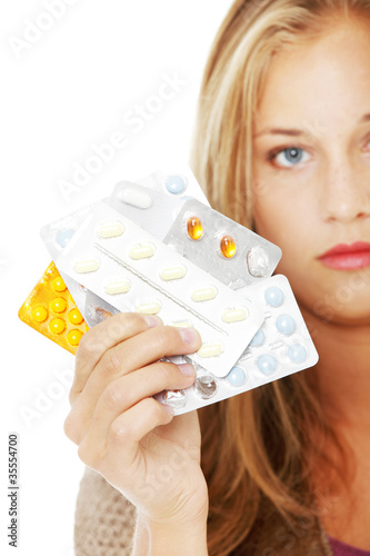Photo: Young beautiful woman with pills. Young beautiful woman with pills.