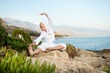 Young woman doing yoga exercise outdoors