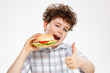 Boy eating big sandwich