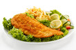 Fish dish - fried fish fillet, French fries with vegetables Fish dish - fried fish fillet, French fries with vegetables