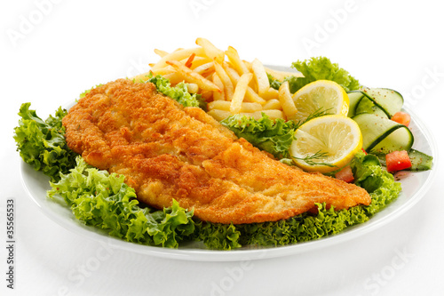 Photo: Fish dish - fried fish fillet, French fries with vegetables Fish dish - fried fish fillet, French fries with vegetables