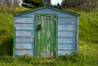 Closeup of an old green-doored fishing shed