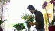 Young woman and client talking in flowers shop