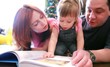 Video: Parents and baby girl are lying on the floor looking book Parents and baby girl are lying on the floor looking book