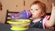 Video: Baby girl is drinking water after end of eating porridge Baby girl is drinking water after end of eating porridge
