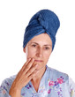 Older woman with head in towel turban, touching face Older woman with head in towel turban, touching face