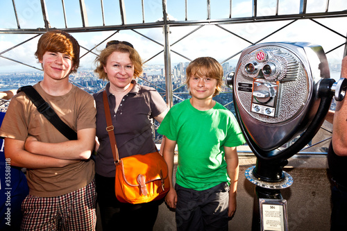 Photo: family on platform of Empire State building enjoys the vacation family on platform of Empire State building enjoys the vacation