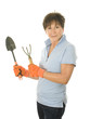 middle age senior woman gardener with spade and cultivator tools