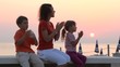 Video: Mom and kids are sitting on bench and claping hands Mom and kids are sitting on bench and claping hands