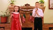 Sister and brother dance and sing song into microphone