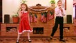 Sister and brother sing song into microphone