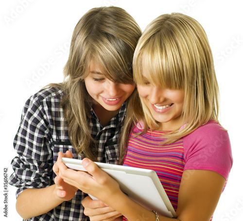 Photo: Teenage girls using touchpad. PC tablet Teenage girls using touchpad. PC tablet