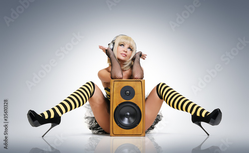 Photo: Glamour sexy young girl in headphones with speaker Glamour sexy young girl in headphones with speaker