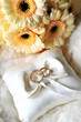 elegant wedding rings on white pillow