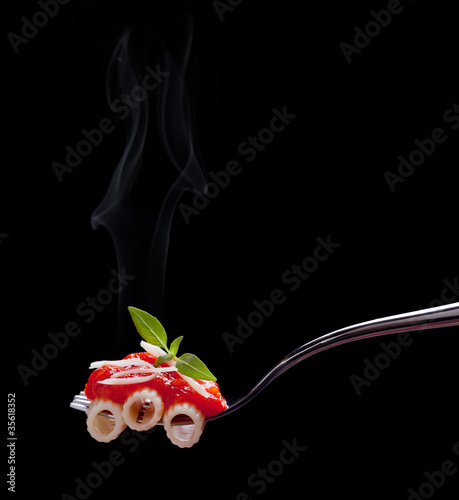 Photo: Fork with macaroni, tomato sauce and cheese Fork with macaroni, tomato sauce and cheese
