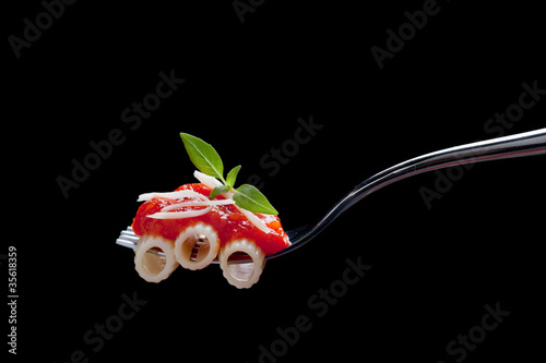 Photo: Fork with macaroni, tomato sauce and cheese Fork with macaroni, tomato sauce and cheese