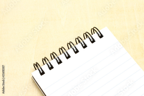 Photo: Open notepad close-up on a wooden background Open notepad close-up on a wooden background