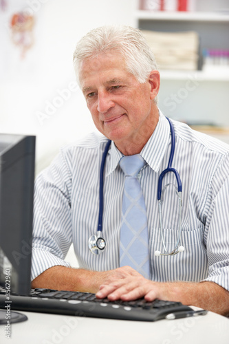 Photo: Senior doctor at desk Senior doctor at desk