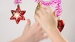 Childrens hands touches christmas-tree decoration