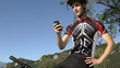 young man with telephone riding mountain bike