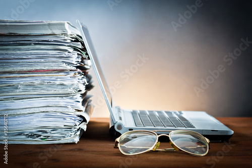 Photo: newspaper,glasses and laptop newspaper,glasses and laptop