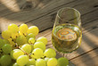 wine and grapes on wooden table